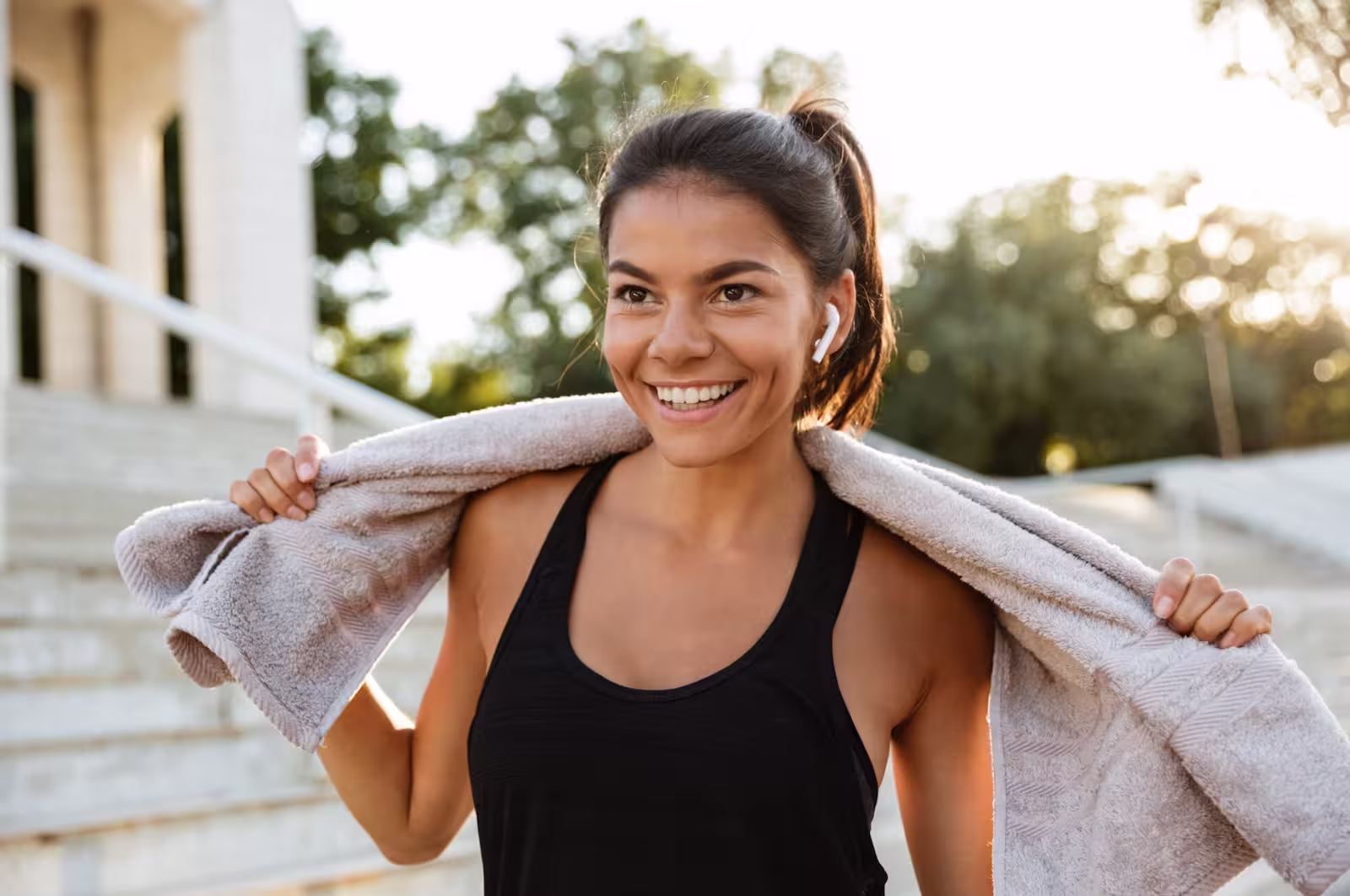 Smiling woman with a towel after a workout