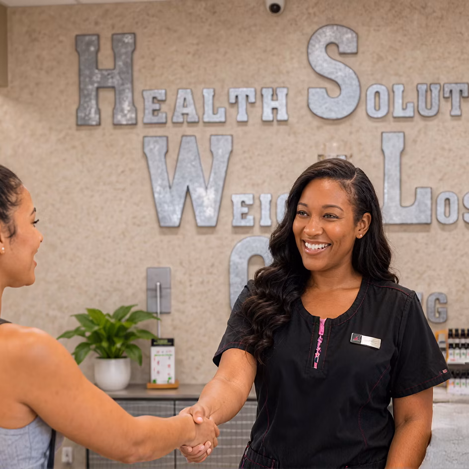 Patient talking with a staff member at the Health Solutions Weight Loss Clinic front desk